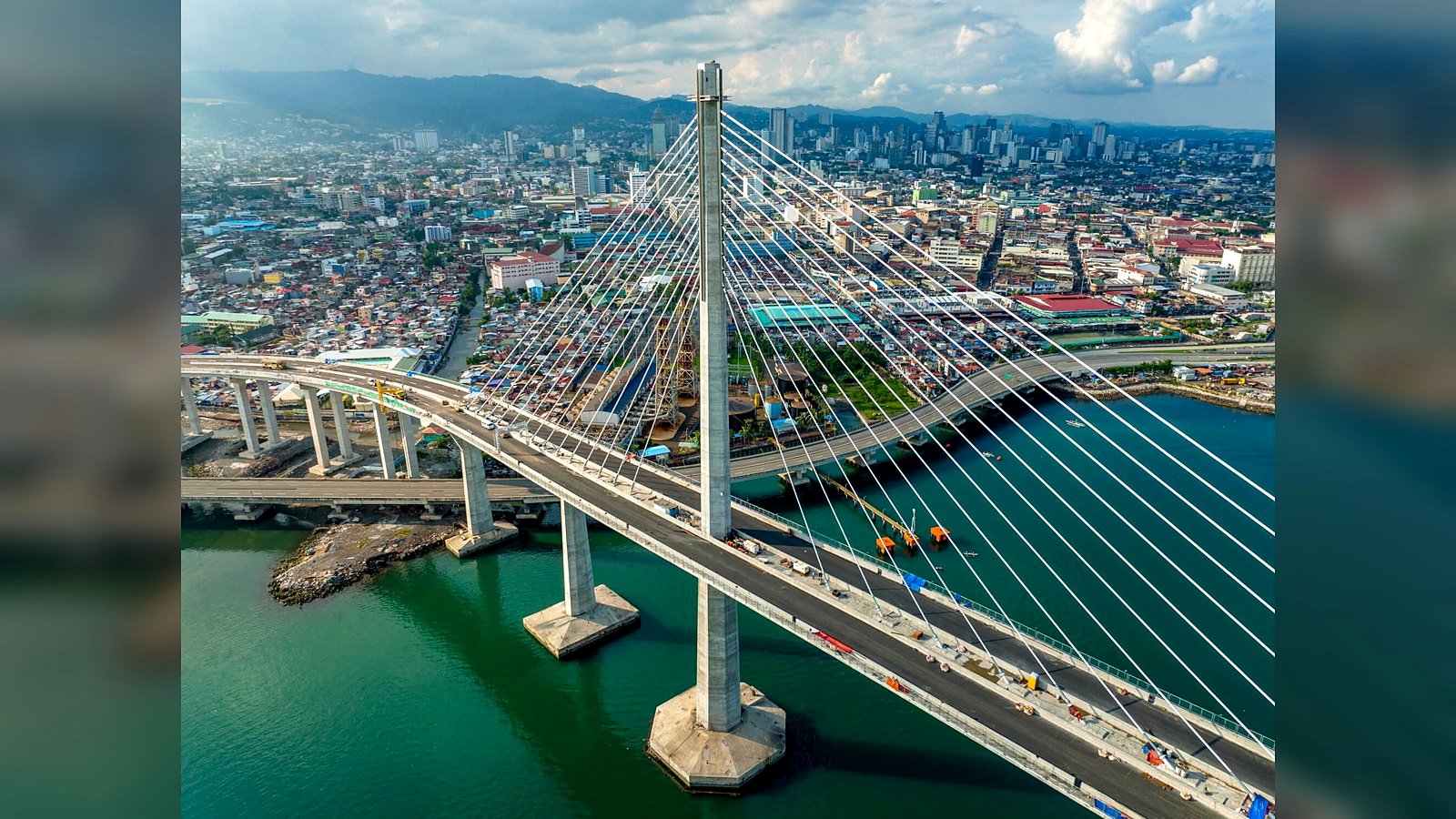 User-supplied aerial photograph of the Cebu-Cordova Link Expressway across the Mactan Channel, illustrating coastal connectivity toward Cordova and Mactan.