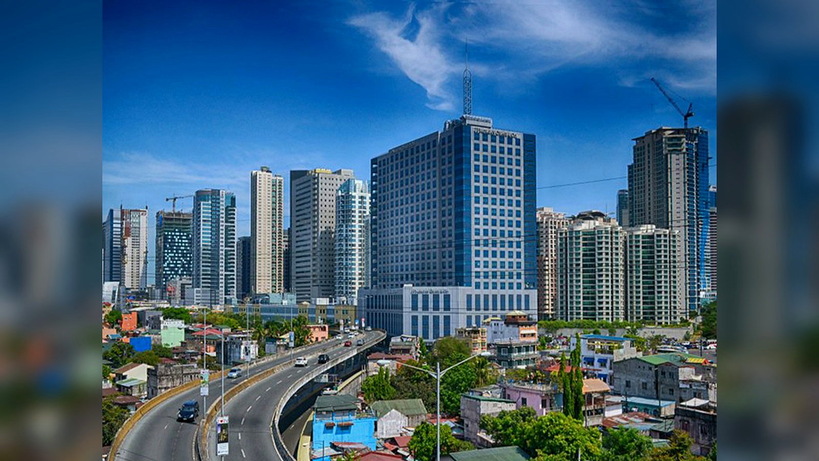 User-supplied Metro Cebu urban view showing high-rise development and a major road corridor, used as connectivity context for Mandaue City.