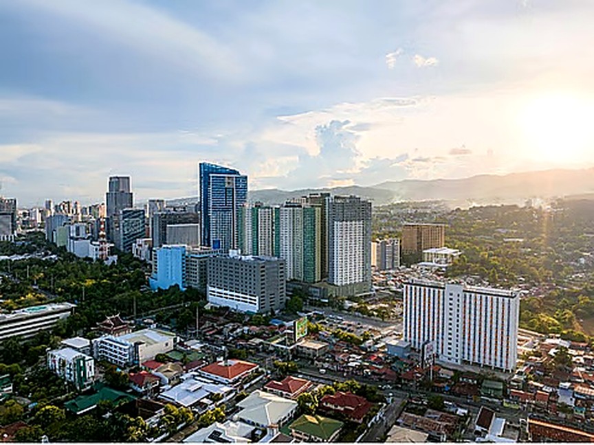 Cebu City skyline with high-rise buildings, low-rise neighborhoods and hills